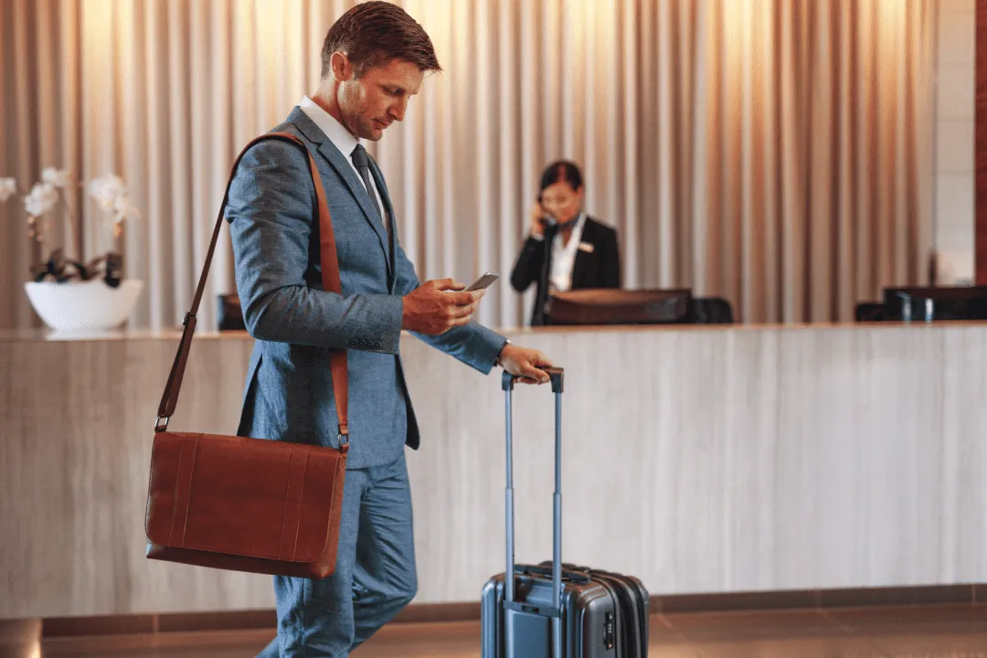Man with a suitcase at reception