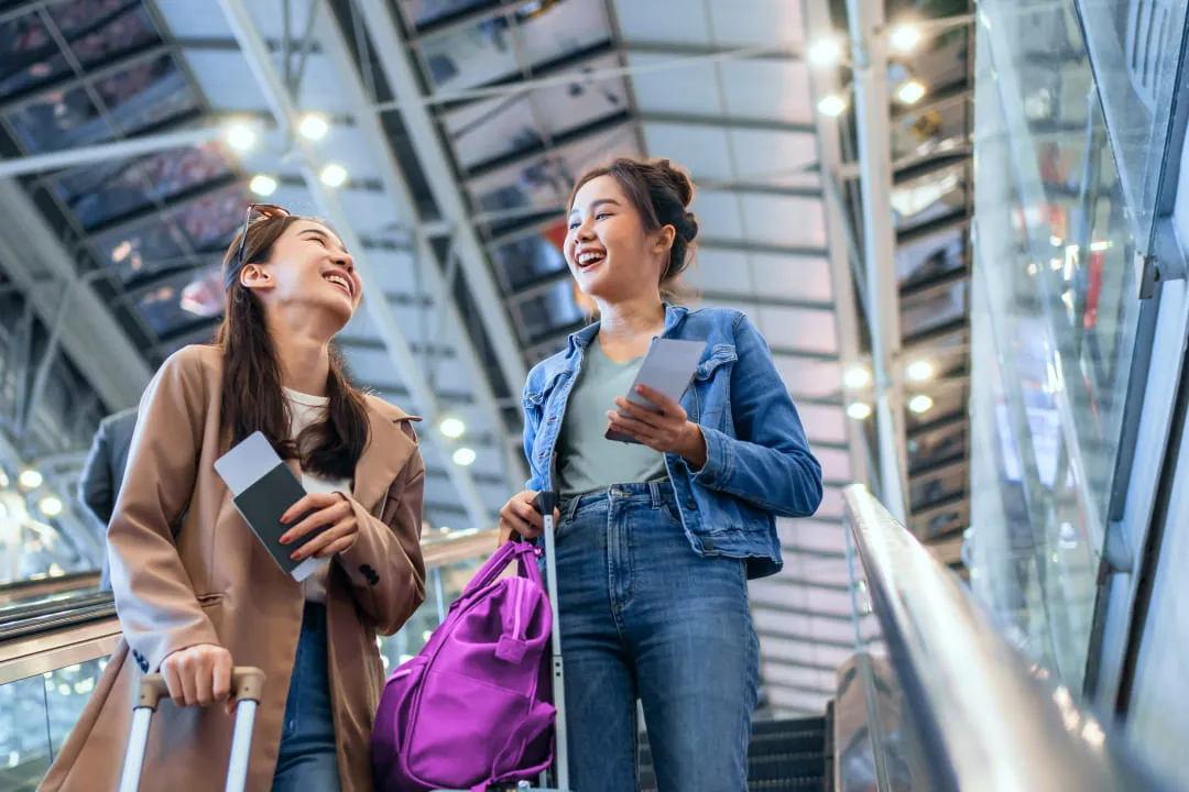 Girls going down an escalator and chatting