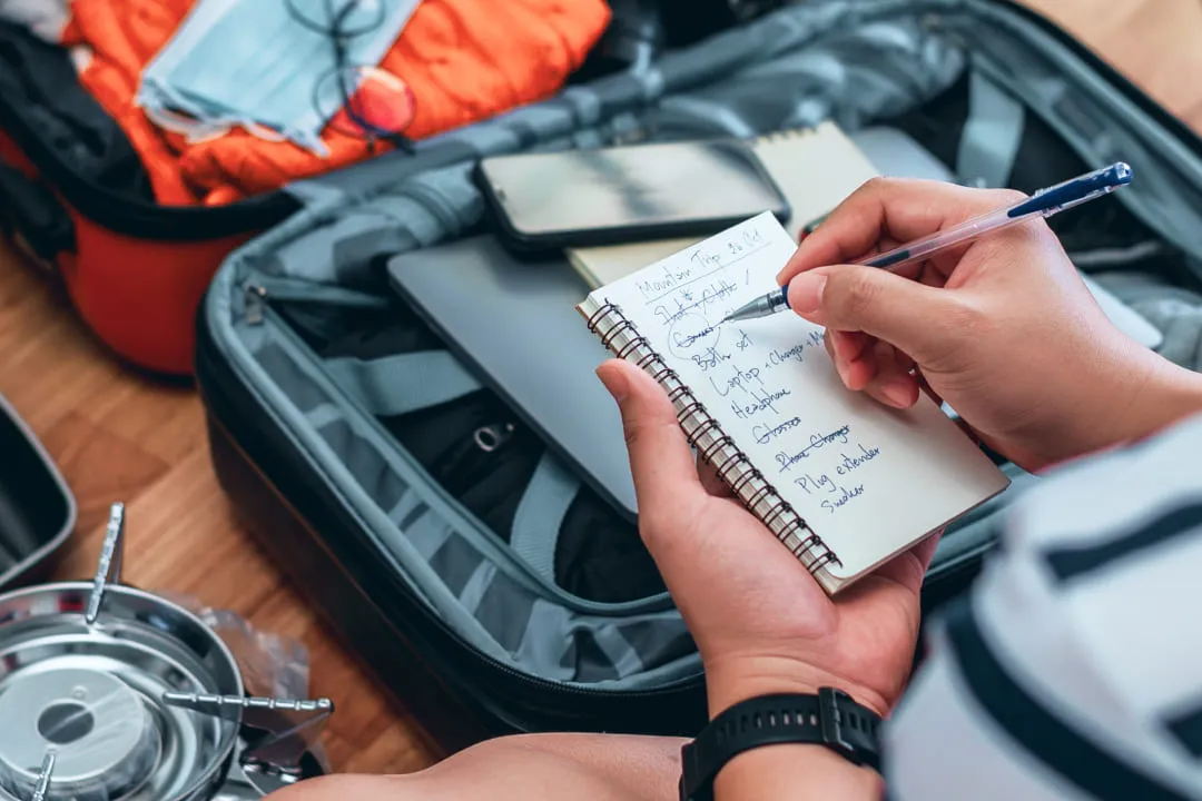 Person crossing out text in a notebook