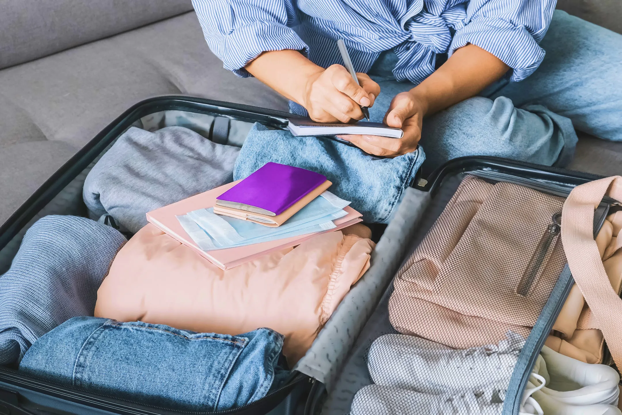 A person packing a suitcase