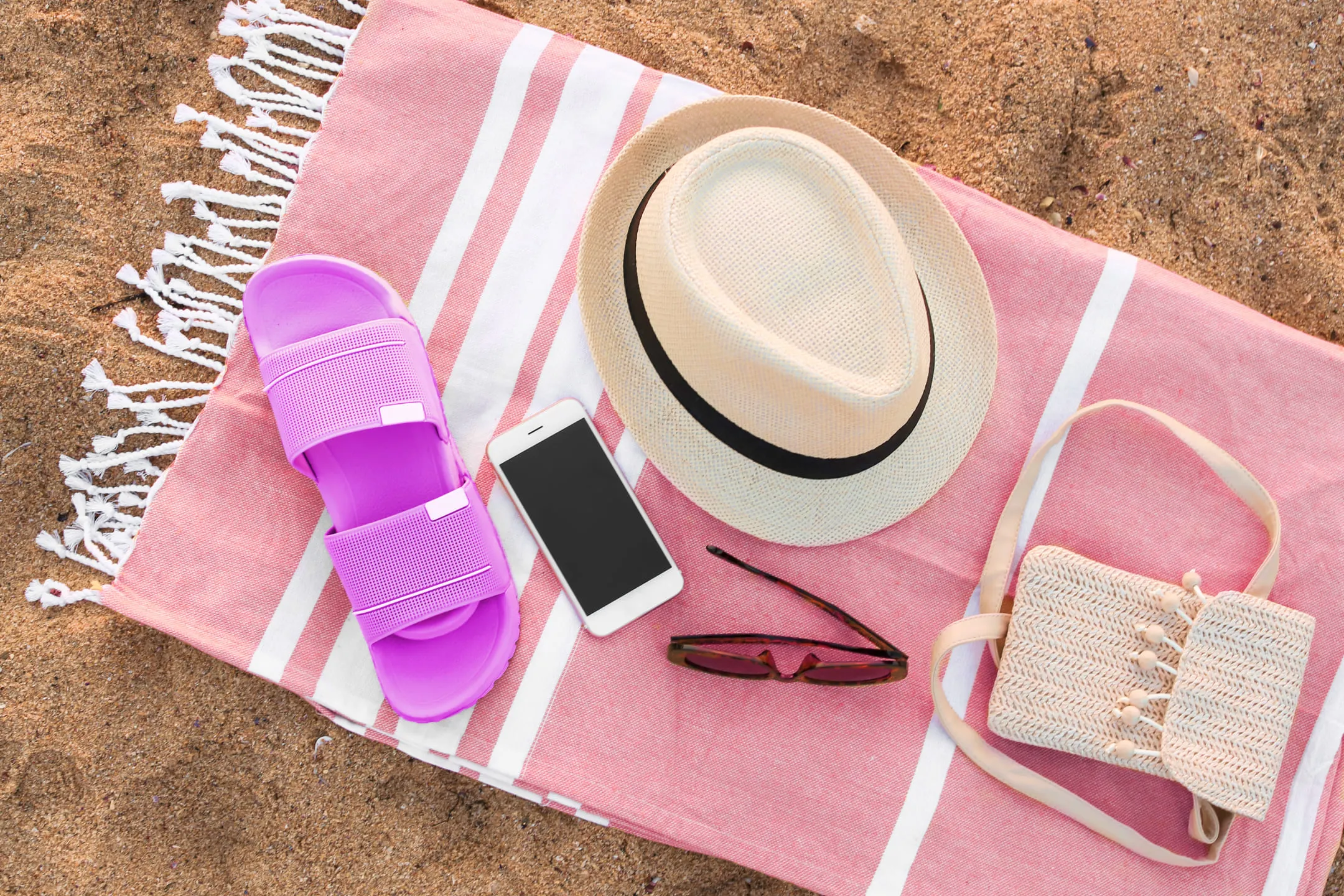 Beach accessories on a pink towel