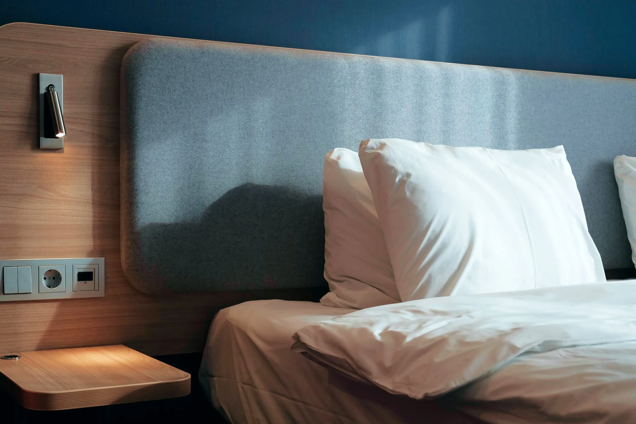 White pillows on a wooden bed