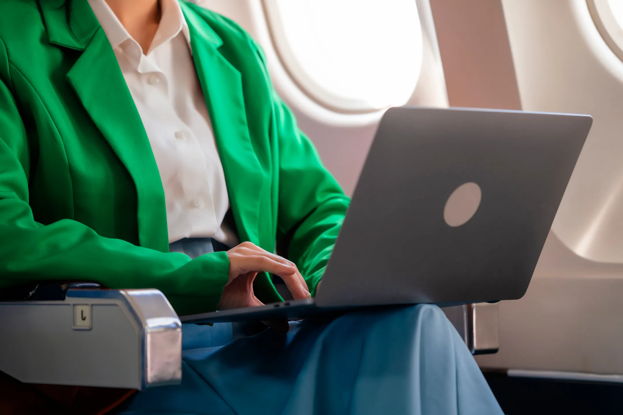 Girl in a green jacket with a laptop