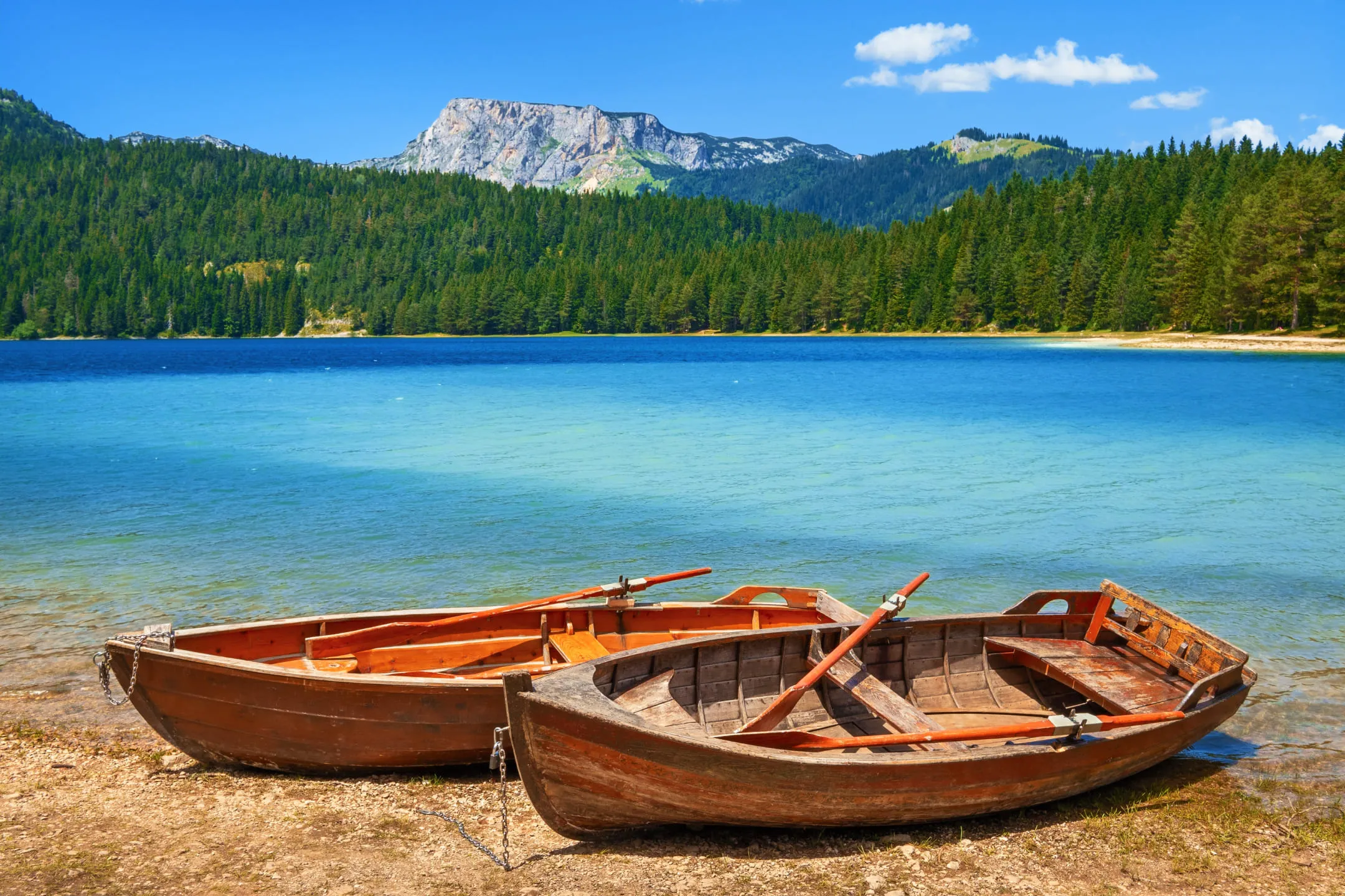 Two wooden boats on the lake shore
