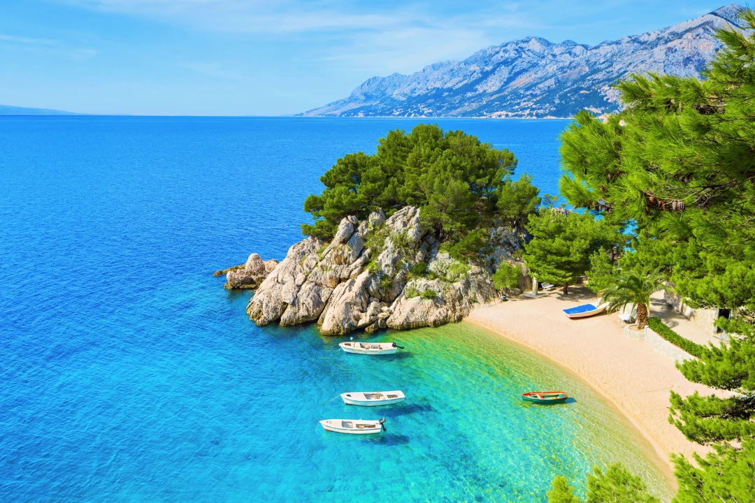 White boats near a beach in the mountains