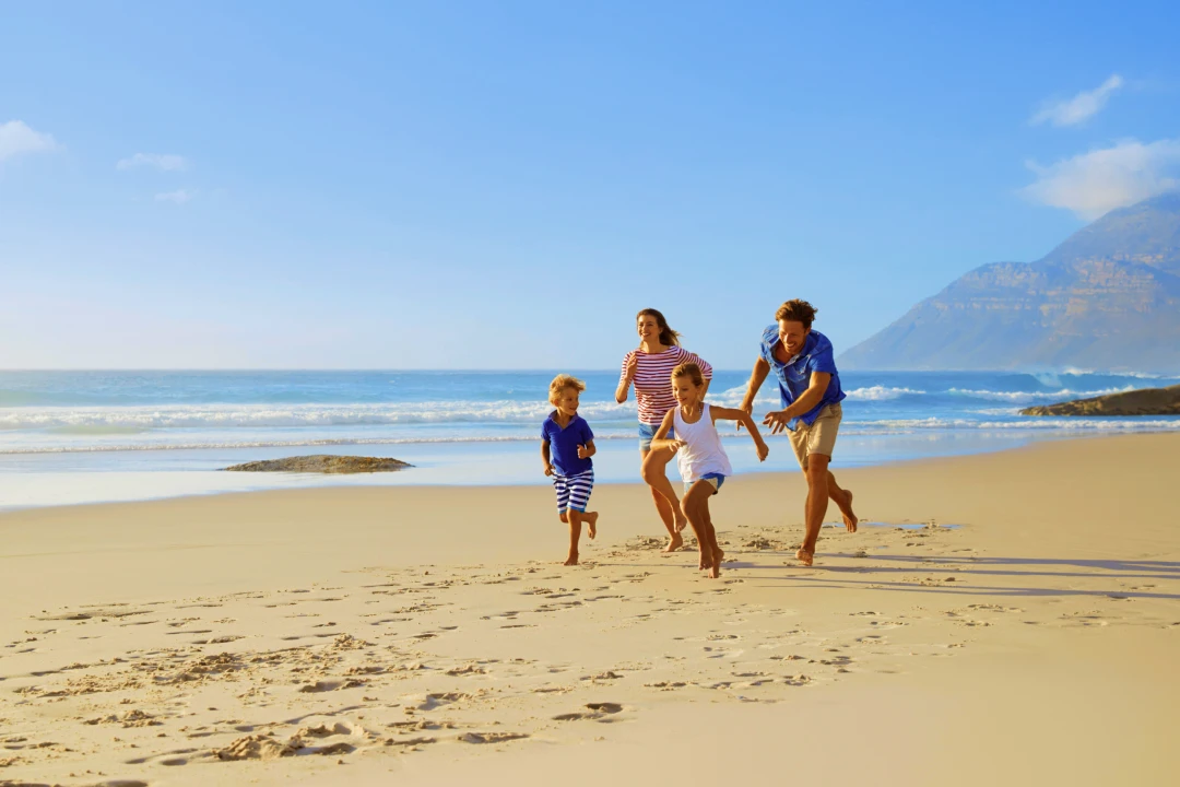 Family playing on a sandy beach