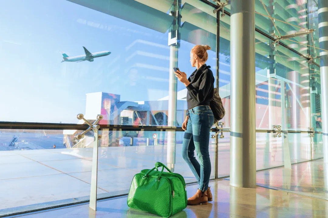 Girl watching a plane take off