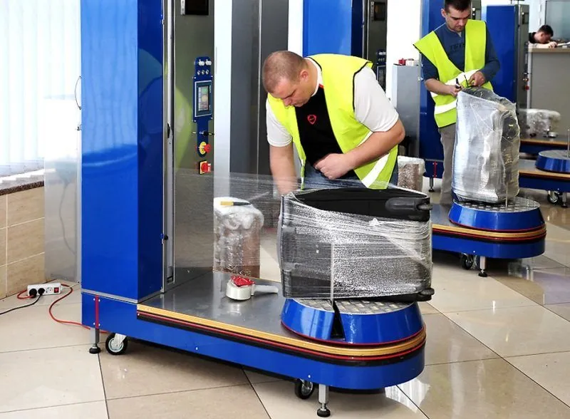luggage wrapping with film at the airport