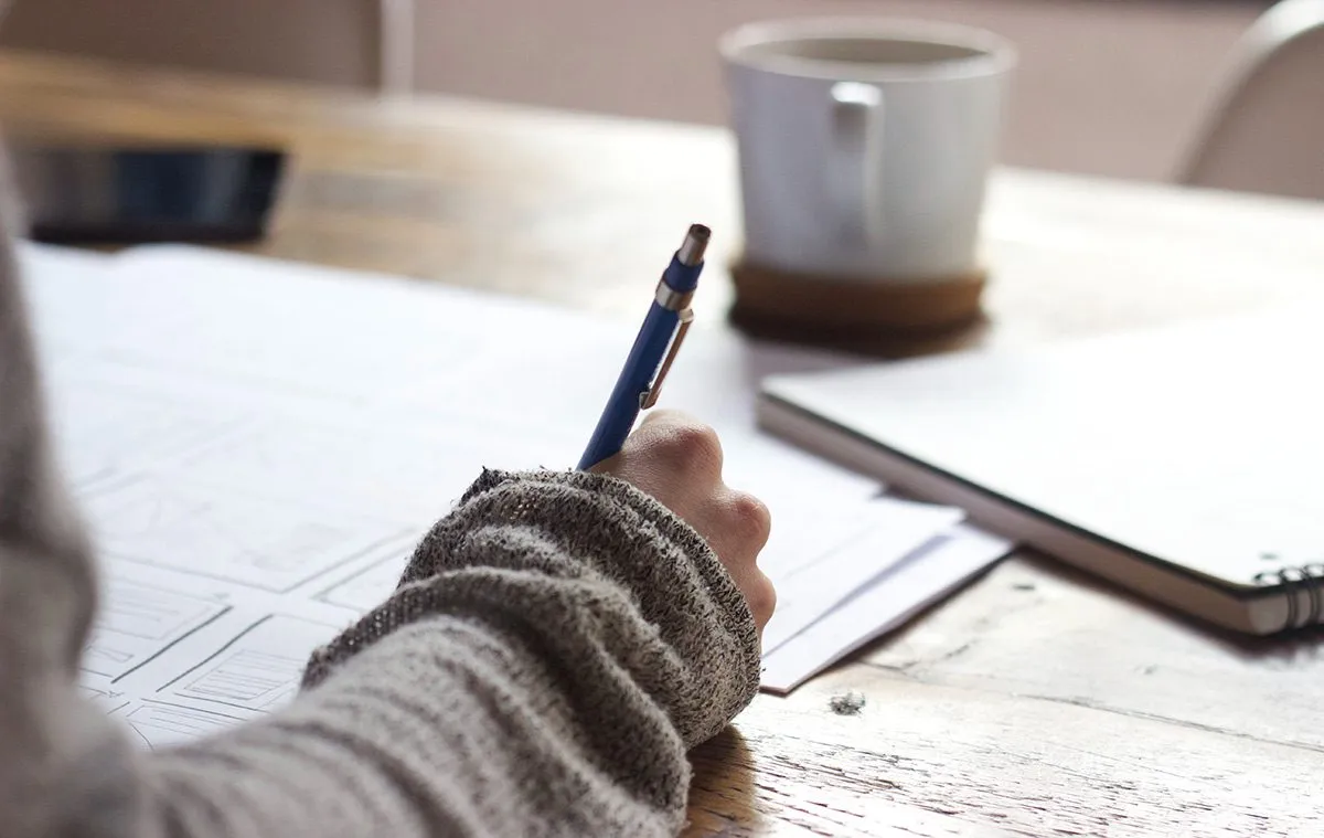 Girl writing information in a notebook