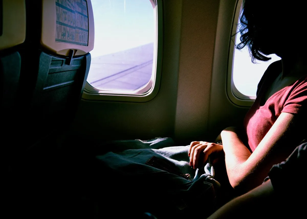 Girl looking out of the airplane window