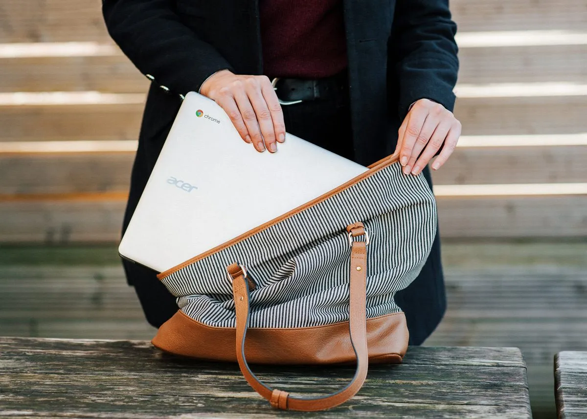 Girl putting a laptop into a bag