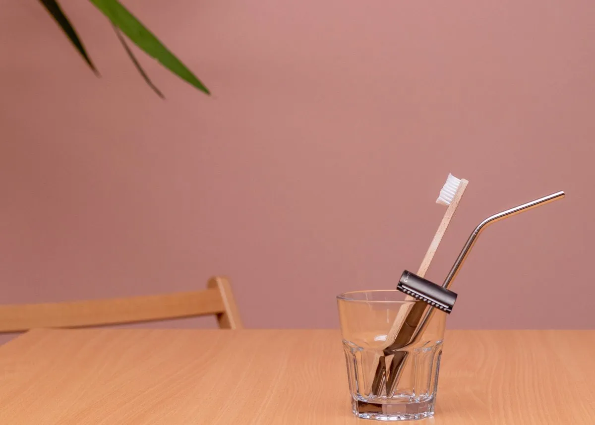 Razor and toothbrush in a clear glass