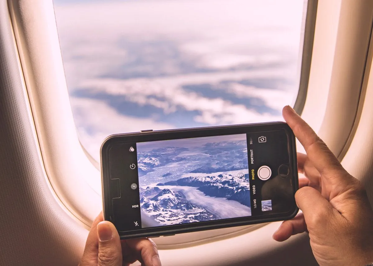 Photograph of mountains from an airplane window