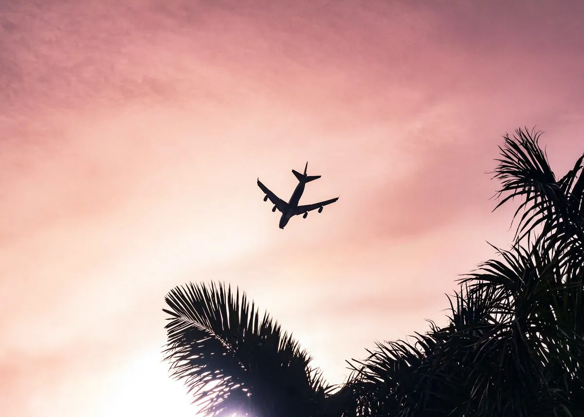 A plane flying over a beach