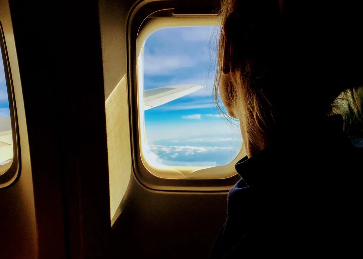 Girl looking out the airplane window