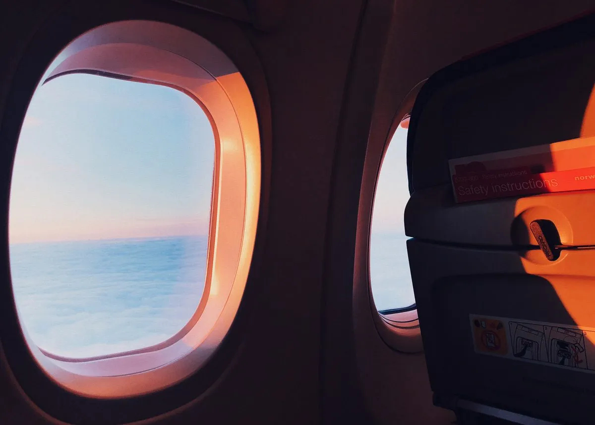 Sunset rays passing through the airplane window into the cabin
