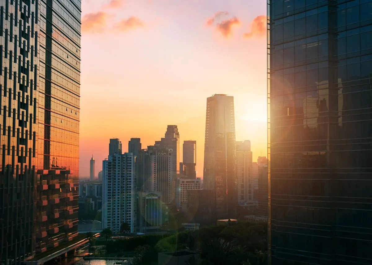 Sunset rays peeking through high-rise buildings
