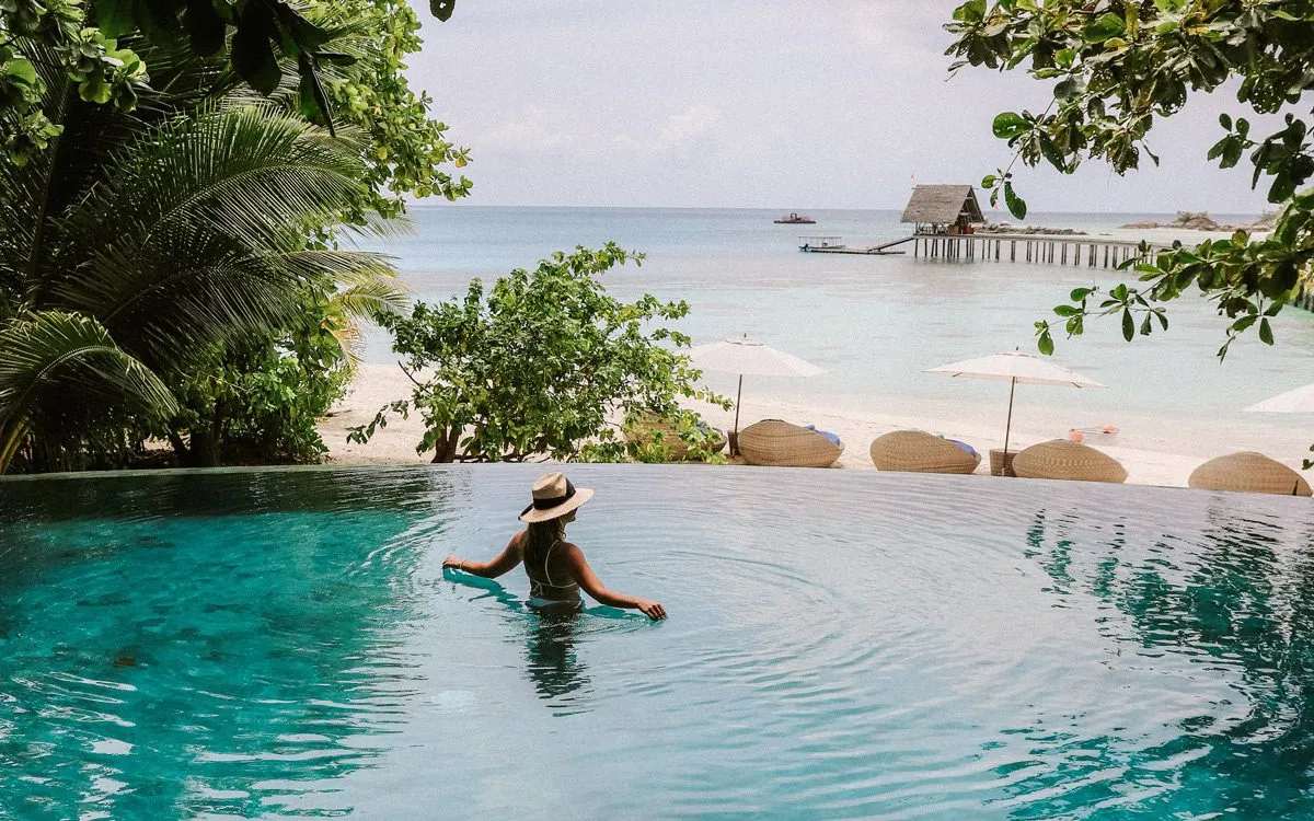 Girl in a pool with an ocean view