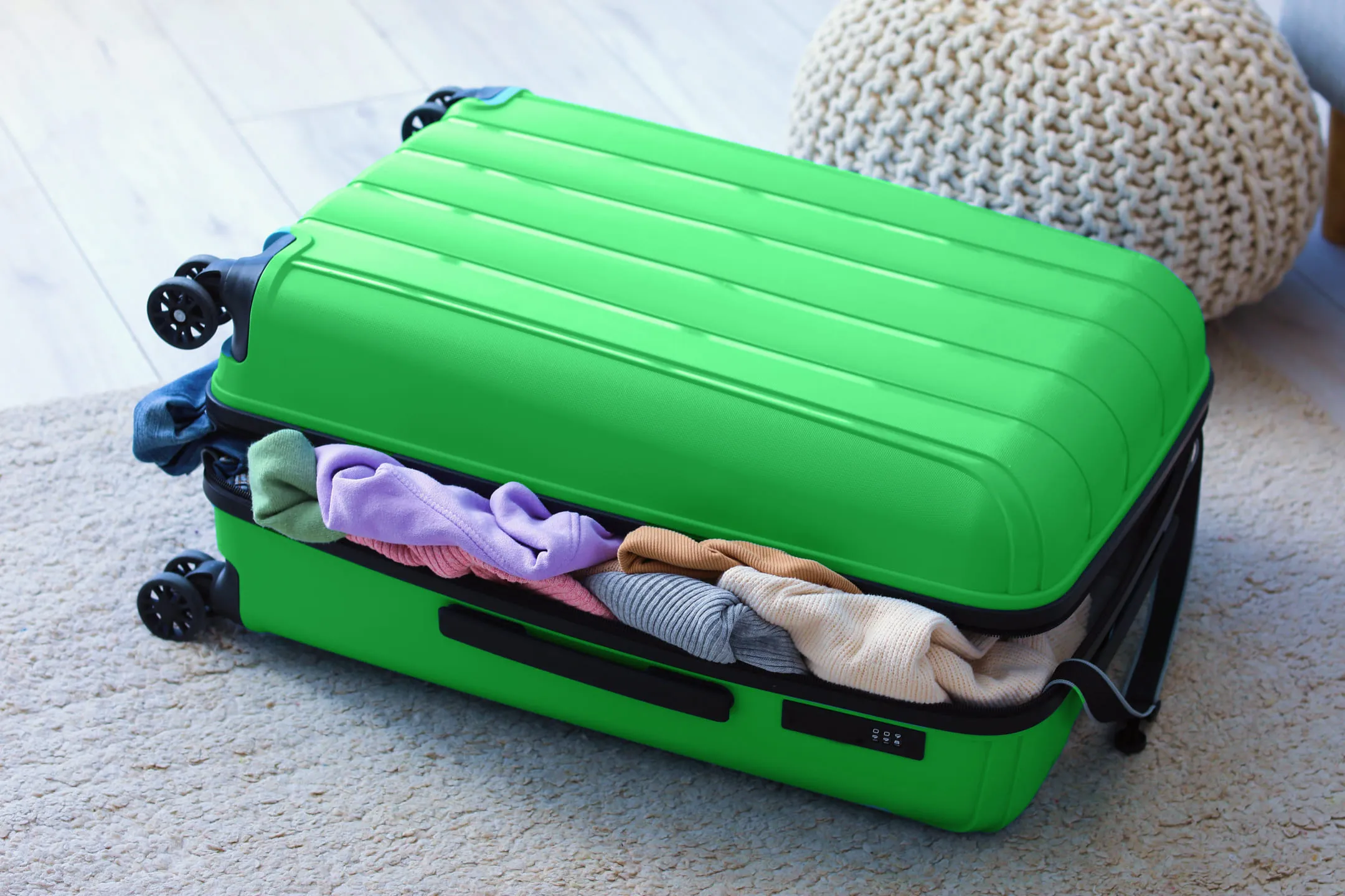 Green suitcase with belongings