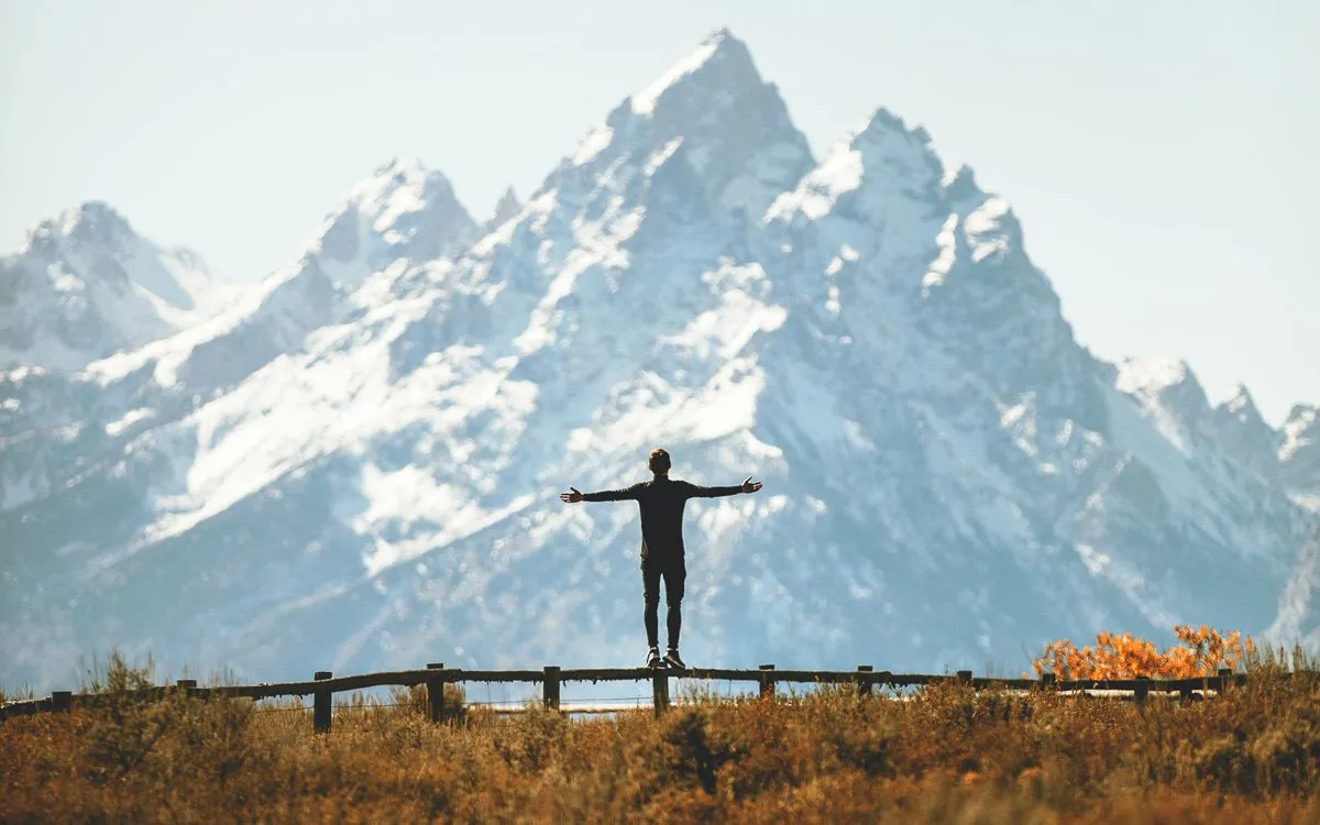 Silhouette of a person against mountains